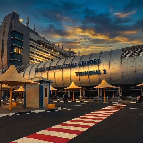 Professional panoramic view of Cairo International Airport Terminal 1 with elite gold and blue reflections for medical tourism logistics in Egypt 2026 