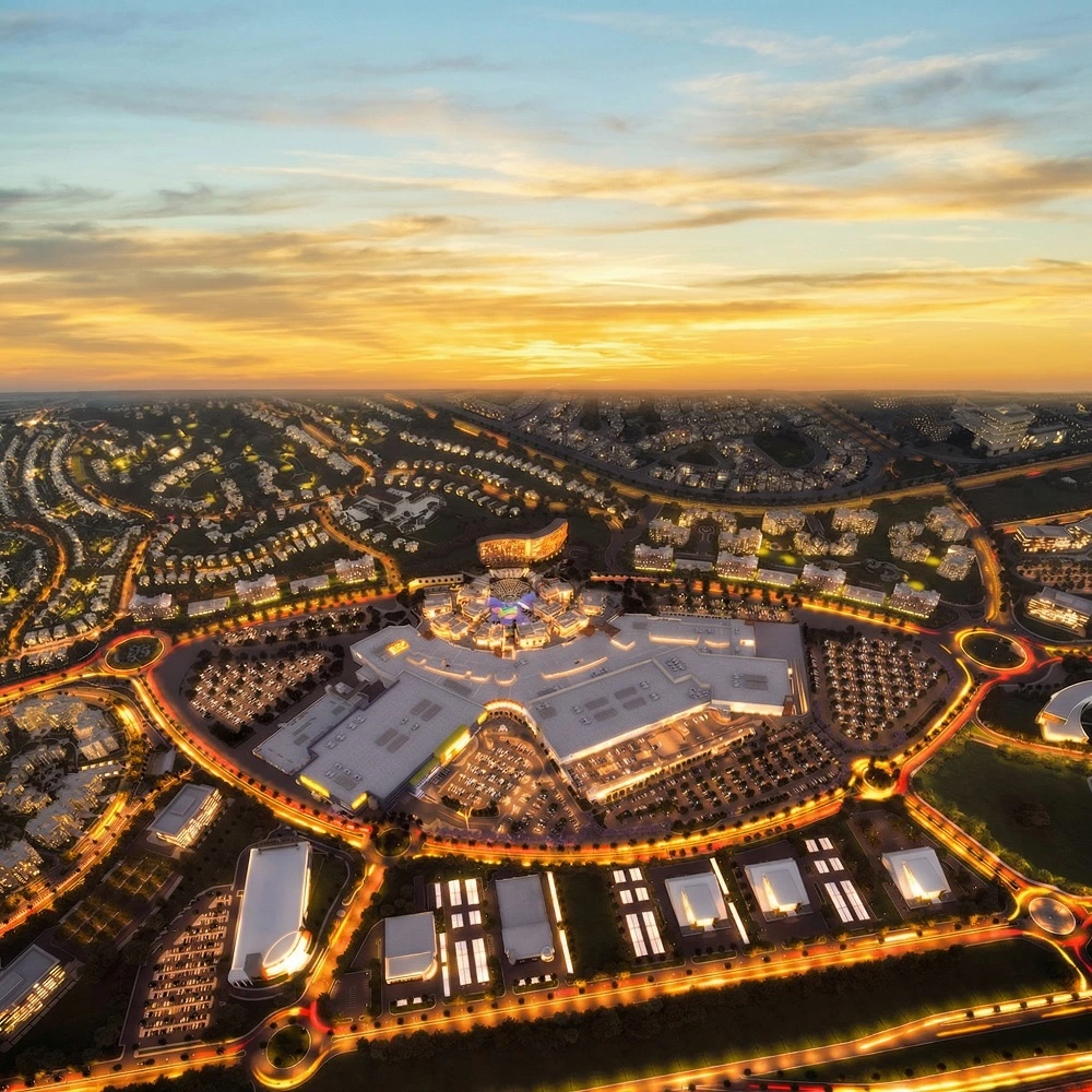 Stunning aerial sunset view of Cairo Festival City (CFC) in New Cairo (Tagamoa), Egypt, a premier luxury hub for Dina Elite medical tourism and concierge clients from Saudi Arabia, United Arab Emirates, Qatar, Kuwait, Bahrain, Oman, Jordan, Iraq, Lebanon, Libya, Palestine, Yemen, Syria, Sudan, Morocco, Algeria, Tunisia, Mauritania, Djibouti, Somalia, and Comoros 