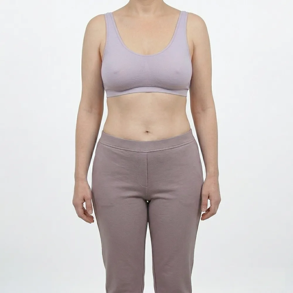 Headless clinical after photograph of the same woman displaying a dramatically flat, rejuvenated abdomen and a lifted, proportional breast contour following a complete Mommy Makeover at Dina Elite for GCC patients 